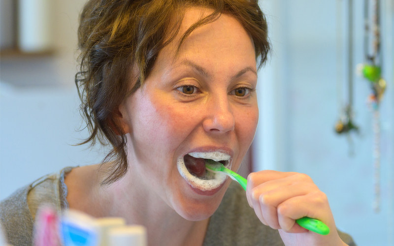 Brushing teeth in mirror
