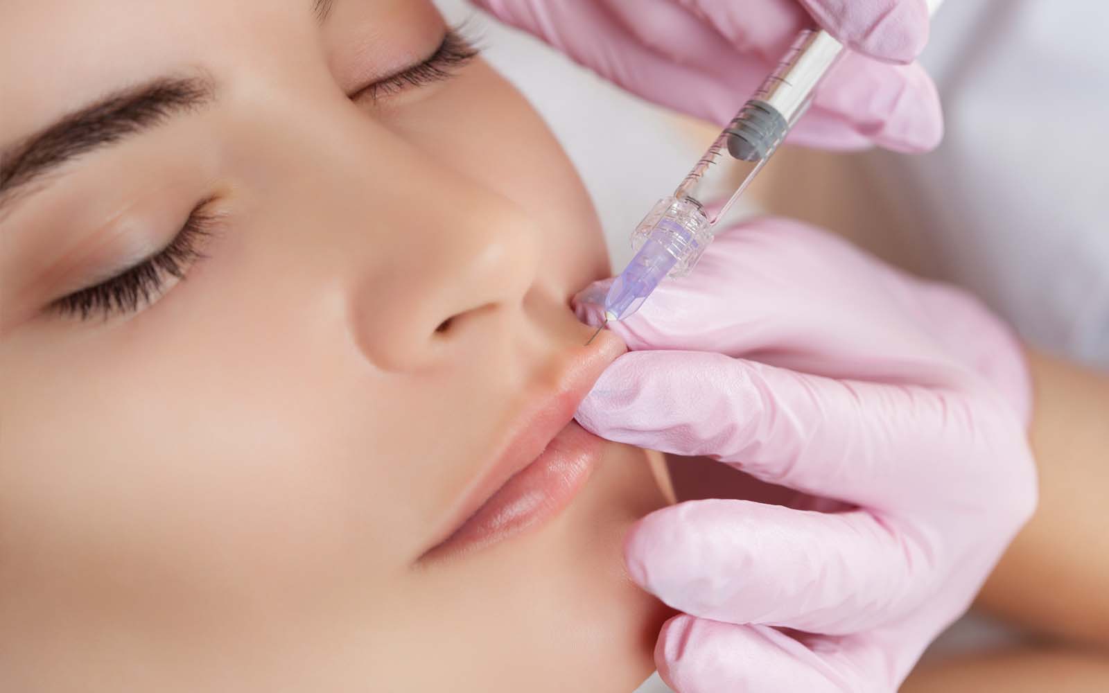 Girl receiving Facial Aesthetics and Rejuvenation for Lip Fillers